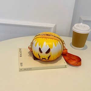 Detail of pumpkin-shaped crossbody bag in yellow and white gradient with orange strap