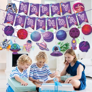 Space themed birthday party decorations with Happy Birthday banner and astronaut swirls
