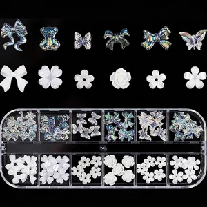 Assorted aurora butterfly and flower nail charms in a 12-grid storage box with size guide