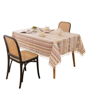 Bohemian linen tablecloth with geometric patterns and fringe edges on white background