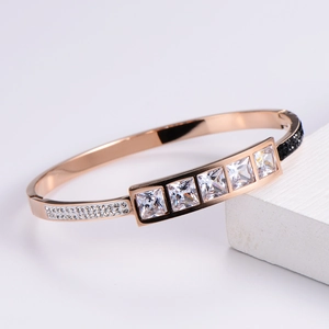 Luxurious rose gold bangle with square zircon and micro-pave crystals on geometric base