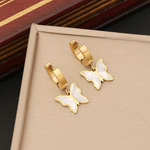 Golden butterfly earrings with white shell inlay presented in a premium jewelry gift box