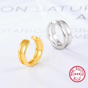 Detailed view of minimal 925 sterling silver twist ear cuffs in gold and silver finish