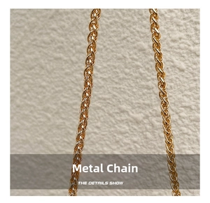 Macro view of a polished golden metallic chain strap with intricate woven texture