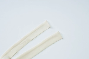 Detail shot of ivory knit tie straps for summer V-neck dress with fine fabric texture