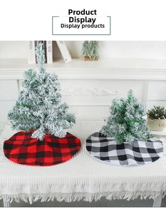 Detail of red and black buffalo plaid Christmas tree skirt on a snowy mini tree base