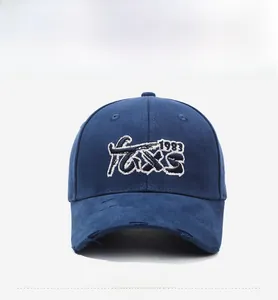 Detailed view of 3D embroidery and vintage distressed rips on navy baseball cap