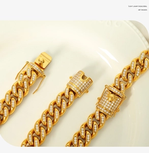 Detailed macro view of 18k gold plated Cuban chain with pavé crystals and secure clasp