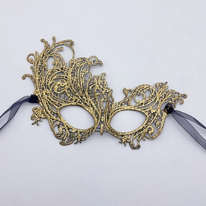 Macro shot of bronze gold lace masquerade mask with intricate embroidery detail