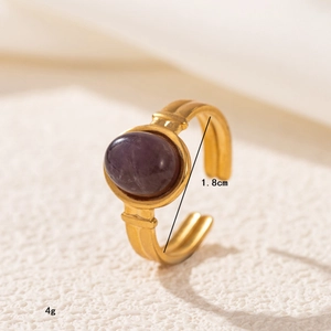 Detailed macro view of 18K gold stainless steel ring with oval purple gemstone inlay