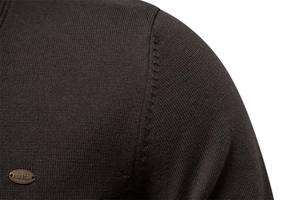 Detailed close-up of dark brown knit sweater shoulder seam and high-quality fabric texture