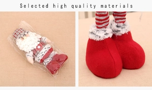 Close-up of Santa plush doll legs featuring red striped socks and large red boots