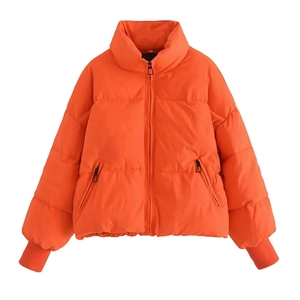 Detail view of bright orange puffer jacket featuring stand collar and ribbed cuffs