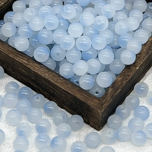 Macro shot of 10mm frosted light blue gradient glass beads for DIY jewelry making