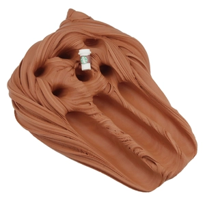 Texture detail of brown butter slime with a miniature coffee cup charm decoration