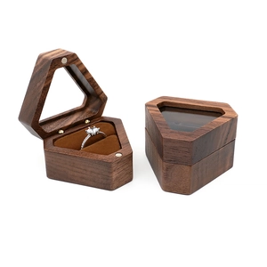 Macro view of vintage hexagonal wooden ring box with velvet lining and glass window