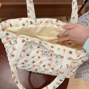 Quilted tote bag interior view showing large capacity and white floral bear print