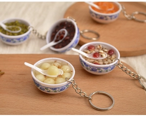 Miniature blue and white porcelain bowl pendants with realistic traditional desserts and spoons