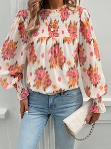 Detail of floral print chiffon blouse showing ruffled collar and vibrant flower patterns