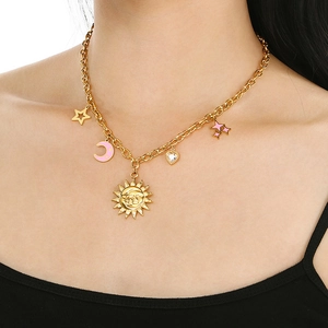 Close-up of 18K gold-plated celestial necklace with sun, moon, and star charms