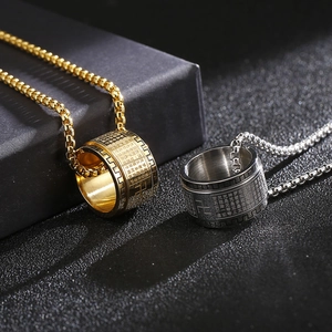 Detailed engraving of Heart Sutra characters on spinning gold and silver titanium rings