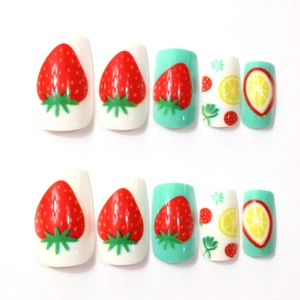 Detailed flat lay of strawberry and lemon press-on nails in white and mint green colors