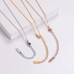 Close-up of 18KGP lobster clasp and extension chain in silver, gold, and rose gold