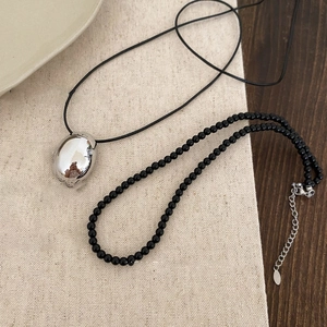 Minimalist black cord necklace with oval silver pendant and beaded strand set