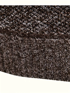 Close-up of deep brown knit fabric with ribbed texture and dense weave patterns