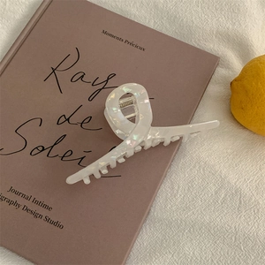 Iridescent pearl white acetate hair claw clip on vintage book with lemon detail