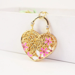 Golden heart-shaped bag pendant keychain with floral enamel and pink crystals