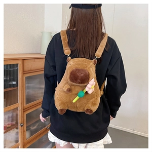 Rear view of a model wearing the cute brown plush Capybara backpack with a pink flower