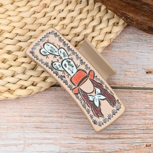 Western style cactus and cowboy hair claw clip on rustic woven background