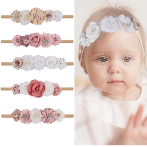 Detail of 5-piece floral baby headband set featuring soft nylon bands and fabric flowers