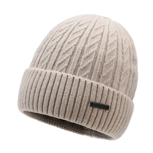 Winter cable-knit beanie in beige with ribbed cuff and metal tag on white background