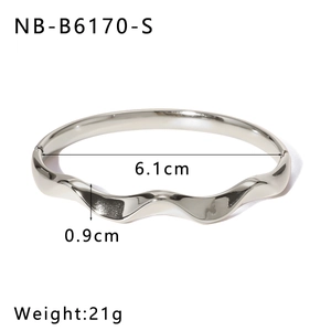Detail view of wavy stainless steel bangle with dimensions 6.1cm diameter and 0.9cm width