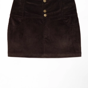 Brown corduroy mini skirt with high waist and three gold buttons on a white background
