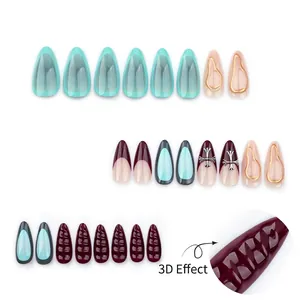 French almond press-on nails set with 3D texture and metallic cross charm details