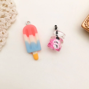 Close-up of resin popsicle and soda can charms for DIY jewelry and keychain crafts