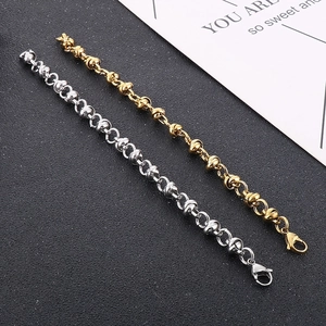 Close-up of gold and silver knot-link chains with high-polished metallic finish
