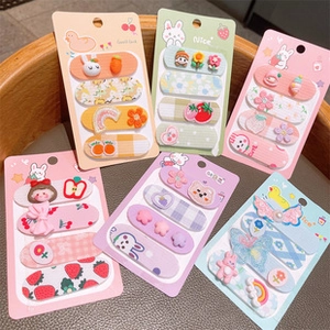 Close-up of cute cartoon hair clips set with rabbit, flower, and bow designs for girls