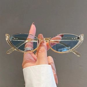 Fashionable champagne cat-eye sunglasses with blue tinted lenses and metal rivets