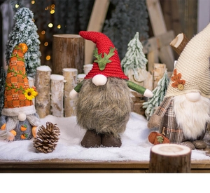 Close-up of knit Christmas gnomes on logs with pine cones in a winter forest scene