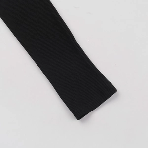Detail of black ribbed knit long sleeve cuff with high quality stitching and texture