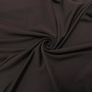 Detailed macro view of the dark brown ruched fabric texture and fine knitted material