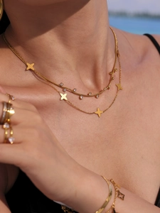 Close-up of double-layer gold necklace with 18k plating and 5A zircon flower charms