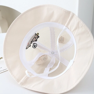 Detail of mesh lining and adjustable chin strap on a beige toddler sun bucket hat