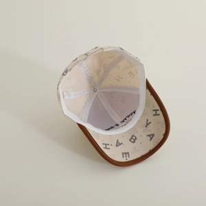 Detail view of corduroy baseball cap interior showing embroidered sweatband and printed brim