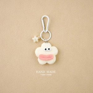 Detail of handmade plush flower charm with cute eyes and transparent glowing star star