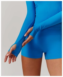 Detail view of Klein blue yoga jacket with practical thumbholes and slim fit sleeves